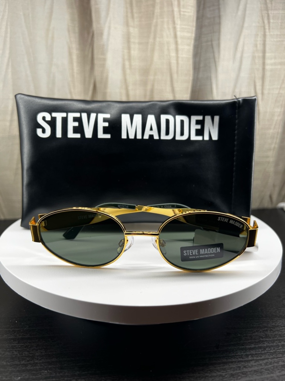 Steve Madden Gold Frame Oval Sunglasses with Dark Green Lenses